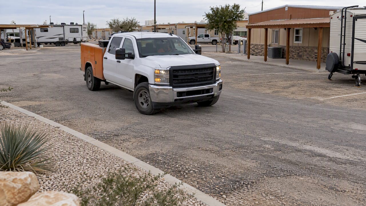 Work truck turning into a wide parking space