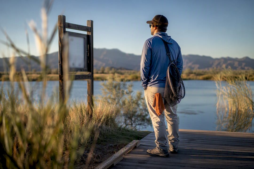 Angler checking pond rules before fishing