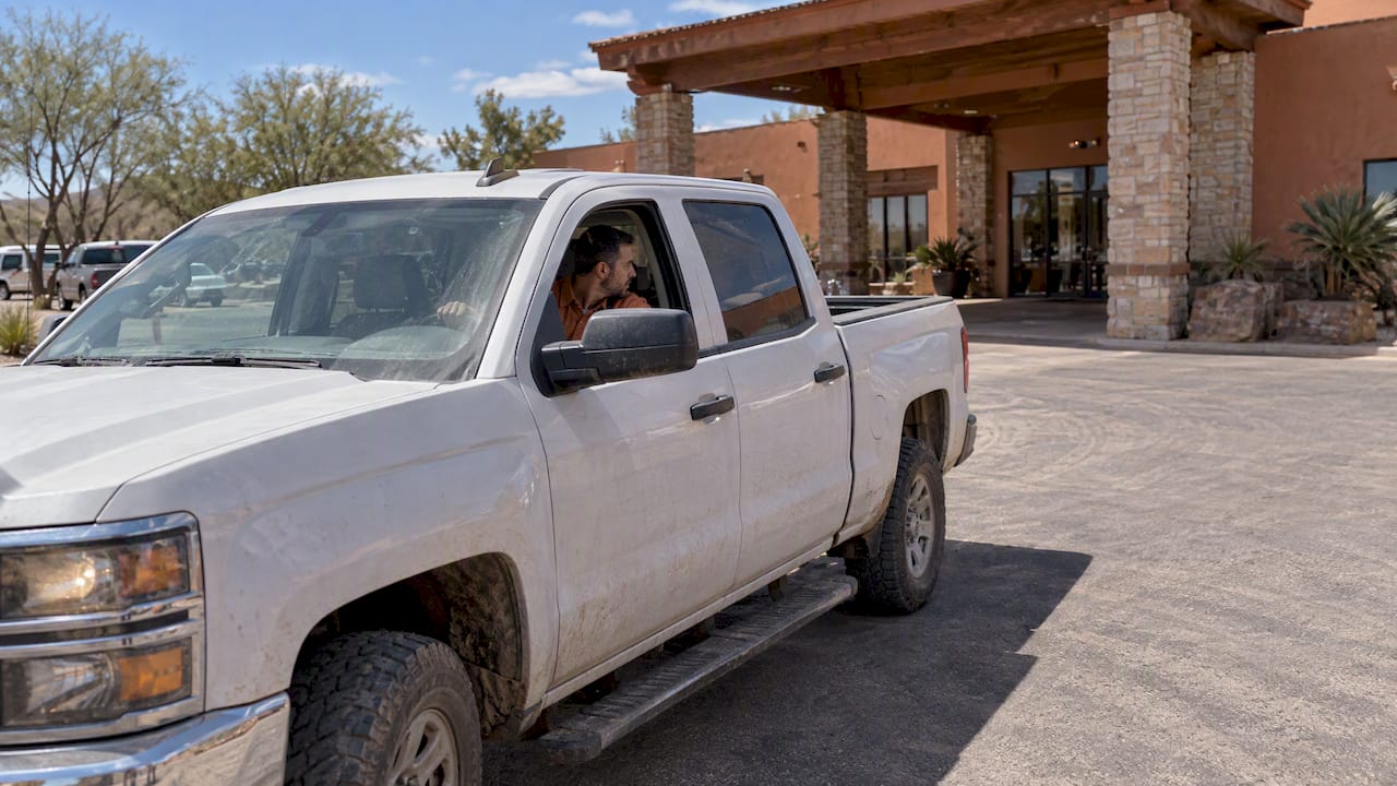 Contractor turning pickup beside Odessa lodge