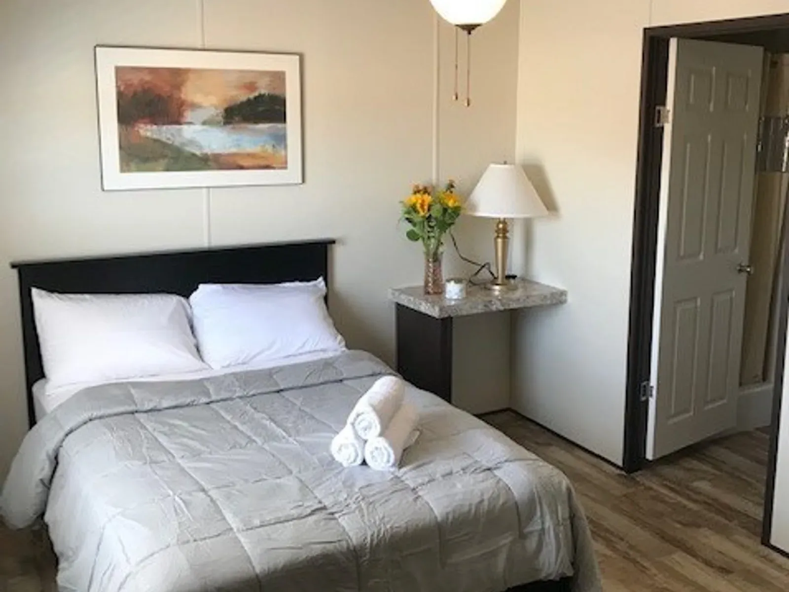 Lodge bedroom with made bed and nightstand