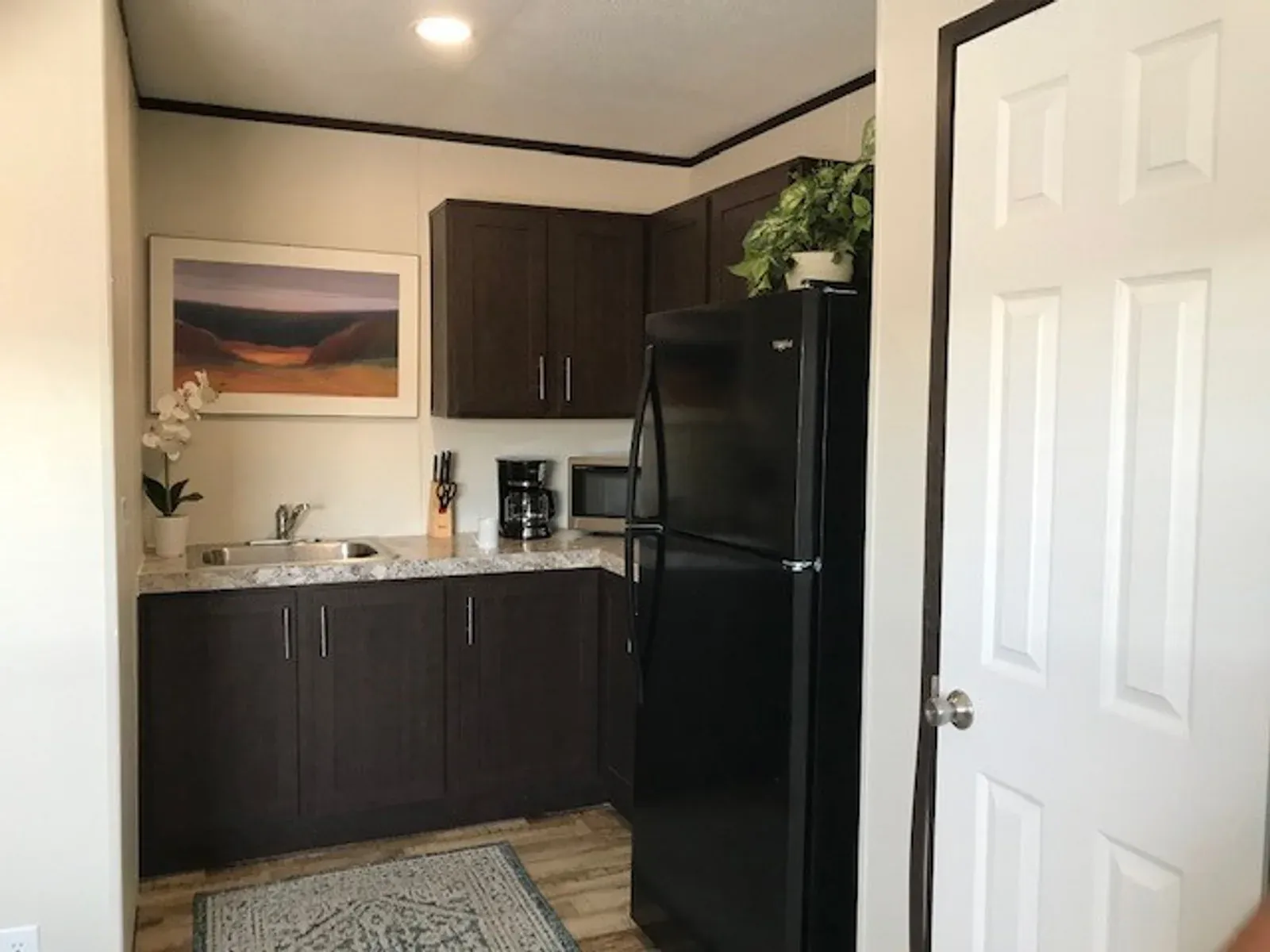 Kitchenette with cabinets, sink and counter in a lodge unit