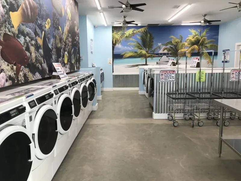 Laundry room with rows of washers and dryers