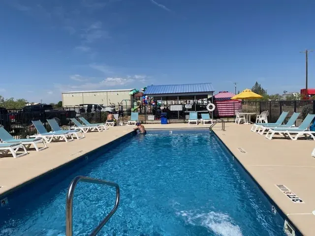 Swimming pool at Mesquite Oasis RV Park with shade structures