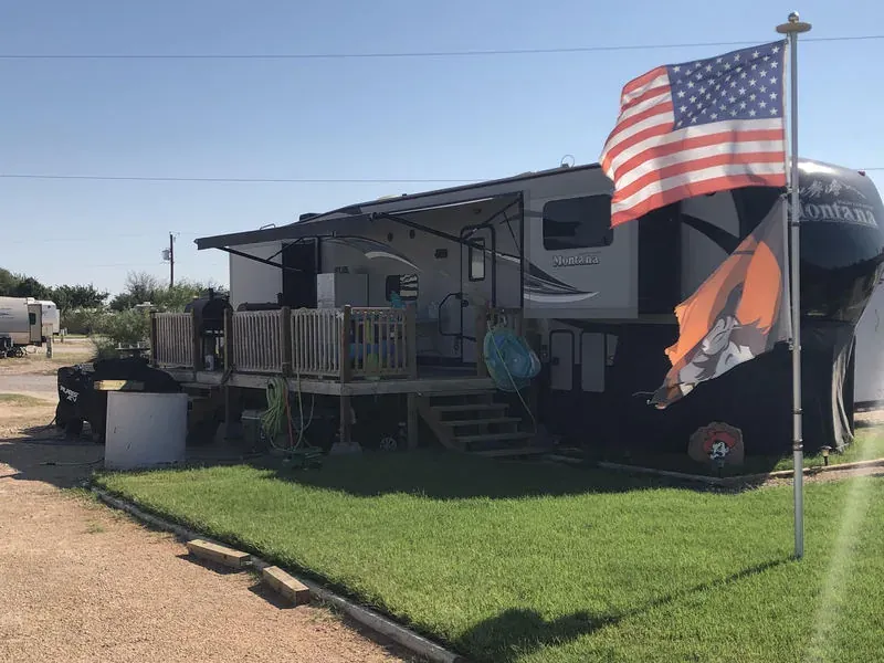 50 amp RV site with a flag pole at Mesquite Oasis RV Park